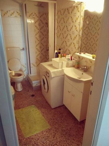 a bathroom with a sink and a washing machine at Sermili's House in Gerakini