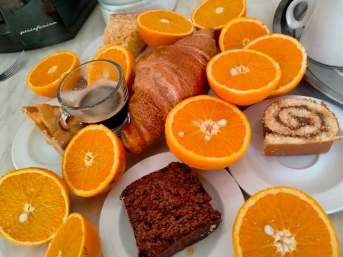 a plate of food with bread and orange slices at Villa Laura Apartment in Giardini Naxos