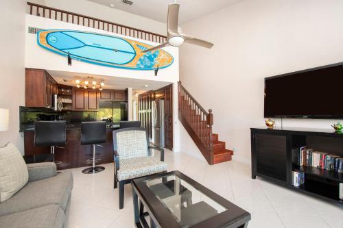 a living room with a couch and a flat screen tv at Beach Living at Island Pine Villas BLAW in George Town