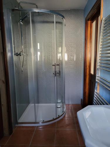 a shower with a glass door in a bathroom at The Annexe in Ulverston