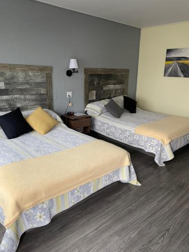 a hotel room with two beds in a room at Motel Valois JM inc in Acton Vale