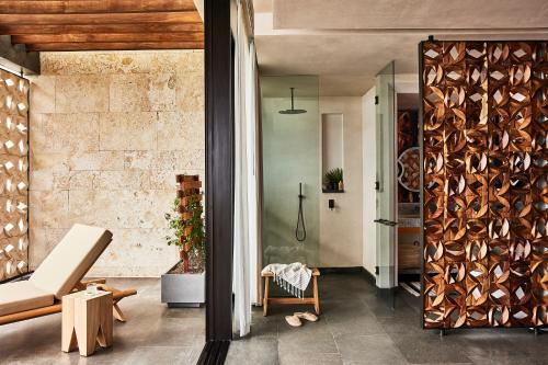 a living room with a wooden wall at Etéreo, Auberge Collection in Playa del Carmen