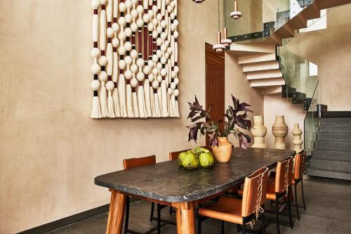a dining room with a table and chairs at Etéreo, Auberge Collection in Playa del Carmen