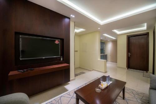 a living room with a large flat screen tv at شقق ركن مدهال جازان للشقق المخدومة in Jazan
