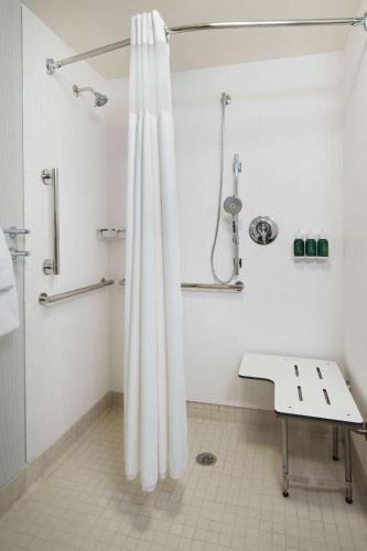 a bathroom with a shower with a shower curtain at Sonesta Select Boca Raton Town Center in Boca Raton