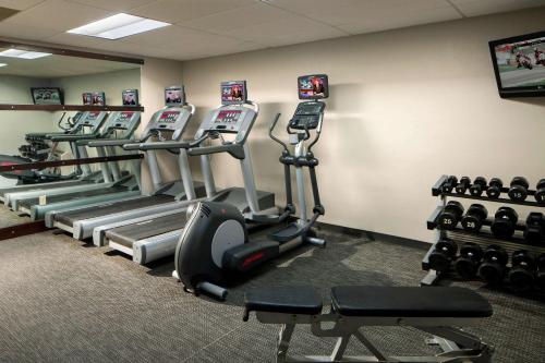 a gym with rows of tread machines in a room at Sonesta Select Boca Raton Town Center in Boca Raton