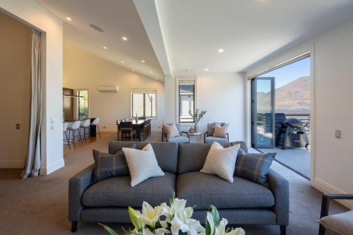 a living room with a couch and a dining room at Picture Point Villa in Queenstown