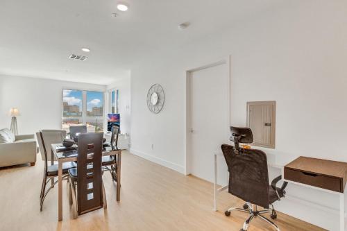 a living room with a table and a clock on the wall at Apart Hotel near Dodgers Stadium in Los Angeles