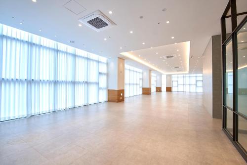 a large room with large windows and a large hallway at Busan City Hotel in Busan
