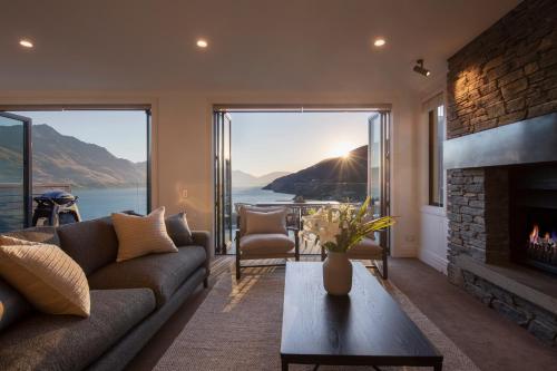 a living room with a couch and a fireplace at Picture Point Villa in Queenstown