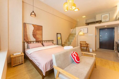 a bedroom with a bed and a couch and a staircase at Locals Apartment House 17 in Jiang'an