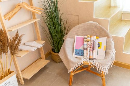 a chair with books on it in a room with shelves at Locals Apartment Inn 16 in Jiang'an