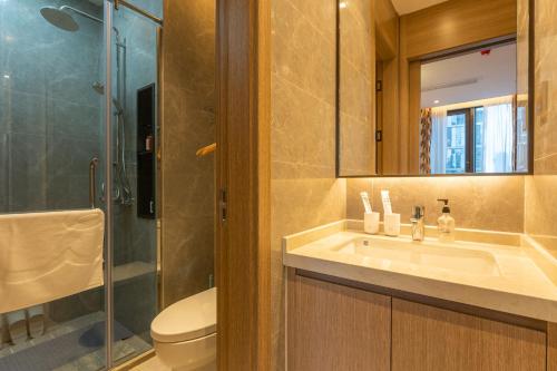 a bathroom with a sink and a toilet and a shower at Locals Apartment Place 25 in Hankou