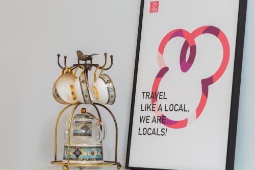 a picture of a clock and a lantern next to a sign at Locals Apartment Inn 04 in Haikou