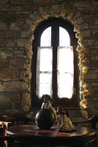 two stuffed animals sitting on a table in front of a window at Hotel Petrino in Makrinítsa