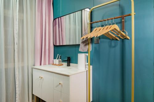 a room with a blue wall and a white cabinet at Locals Apartment House 42 in Changsha