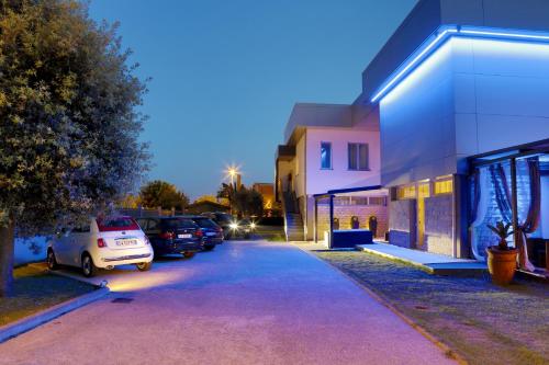 a parking lot with cars parked next to a building at B&B Live09 Design in Pisa
