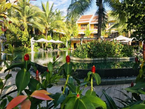 a resort with a pond and a fountain at La Siesta Hoi An Resort & Spa in Hoi An