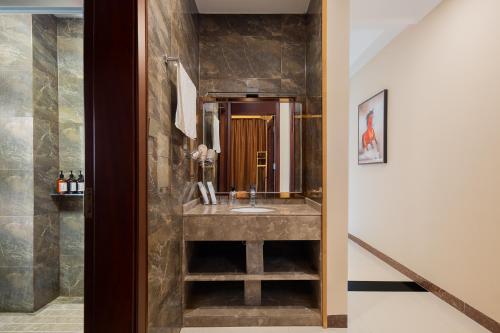 a bathroom with a sink and a mirror at Locals Apartment House 01 in Changliu