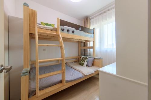 a small room with bunk beds in it at Locals Apartment Inn 14 in Tianjin