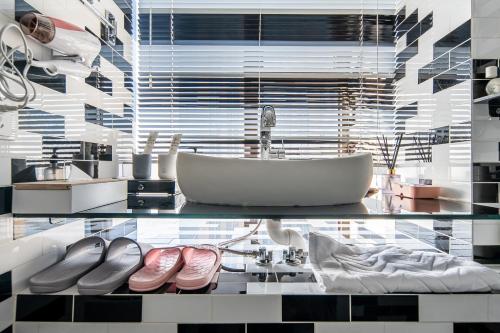a bathroom with a glass table with a sink and a tub at Locals Apartment House 00 in Tianjin