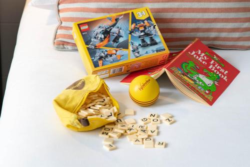 a box of legos and a book on a bed at The Caledonian New Southlands Hotel in Scarborough
