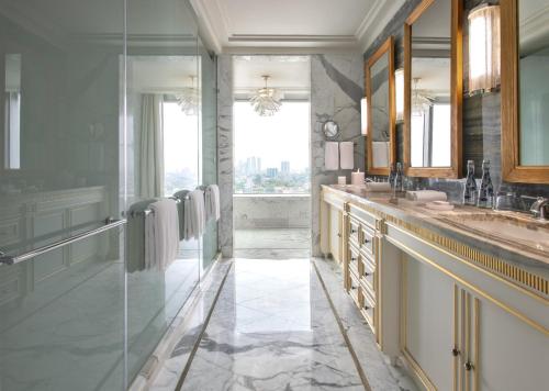 a bathroom with a sink and a mirror at Four Seasons Hotel Jakarta in Jakarta