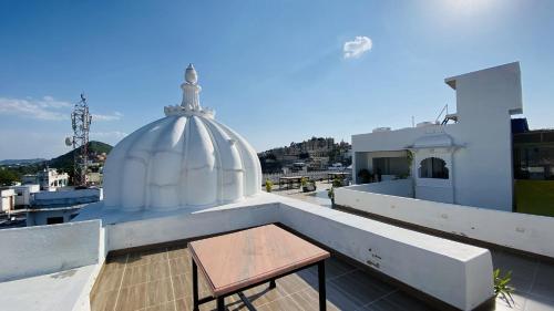 a stool sitting on the roof of a building at Kotra Haveli A Boutique Hotel by Lake Pichola in Udaipur