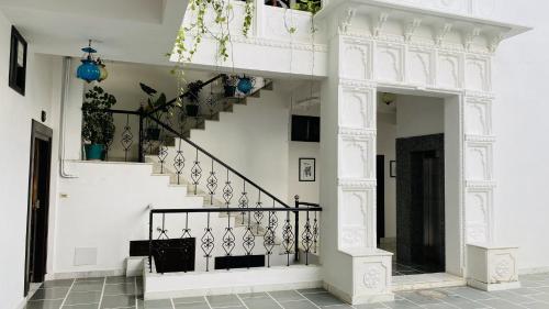 a staircase in a house with white walls at Kotra Haveli A Boutique Hotel by Lake Pichola in Udaipur