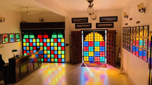 a room with colorful stained glass doors at Kotra Haveli A Boutique Hotel by Lake Pichola in Udaipur