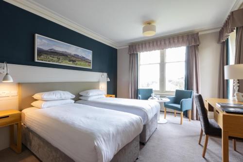 A bed or beds in a room at The Highland Hotel by Compass Hospitality