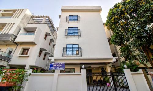 a white building with a sign in front of it at Itsy By Treebo - Shri Guru Service Apartment in Nagpur