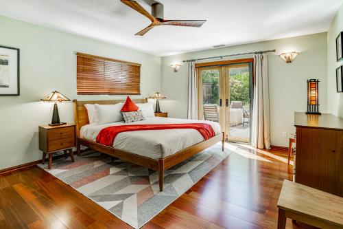 a bedroom with a bed and a sliding glass door at Hillcraft House Fantastic coastal home near beach w/electric car charging station & gas grill in Eden Gardens
