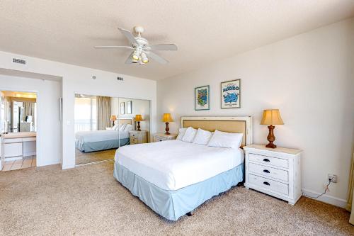 a bedroom with a bed and a ceiling fan at Navarre Beach Regency 308 in Navarre