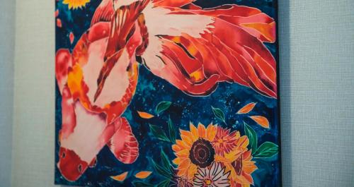 a painting of two kites flying over flowers at HOTEL SANSUI NAHA Ryukyu Onsen Naminoue-No-Yu in Naha