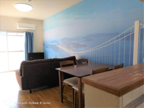 a living room with a couch and a table with chairs at Maison Ota Building A Building B - Vacation STAY 11140 in Takamatsu