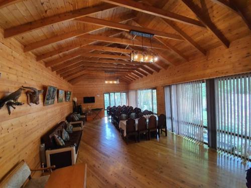 a large room with chairs and tables and windows at Zangazur hotel & cottages in Qusar