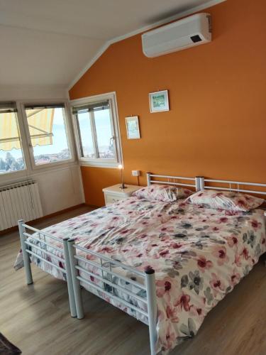 a bedroom with a bed with a floral bedspread at Viewpoint Cannero Apartment in Cannero Riviera
