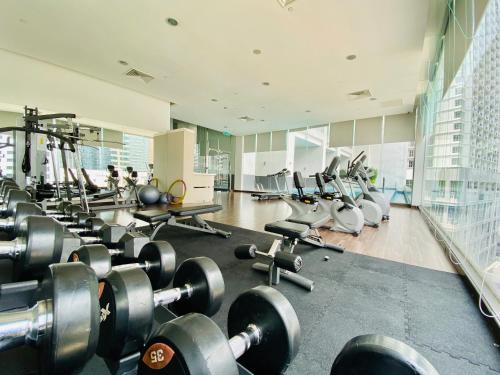 a gym with a bunch of weights and machines at Ramada Suites by Wyndham Kuala Lumpur City Centre in Kuala Lumpur