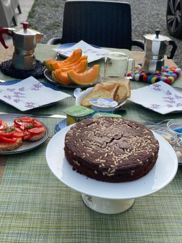 a table with a chocolate cake on a plate at Dolce Vita in Tuscany B&B in Capannori