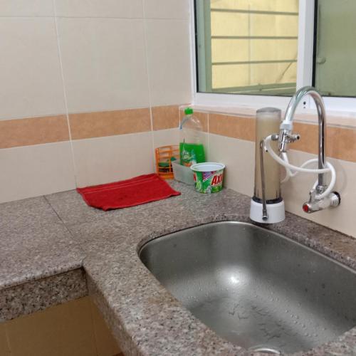 a kitchen sink with a red rag on a counter at Stay 707 Apartment , homestay Melaka , unit 1-11 in Malacca
