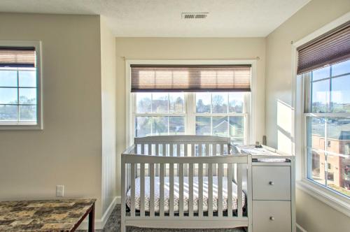 a baby crib in a room with two windows at Harrisonburg Retreat with Hot Tub about 2 Mi to JMU in Harrisonburg