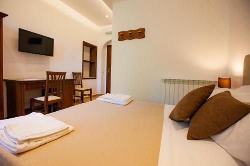 a bedroom with a bed with two pillows on it at Il Carmine Dimora Storica in Erice
