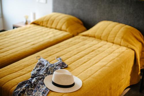 a hat sitting on top of a bed at Cosmo Napa Boutique Hotel in Ayia Napa