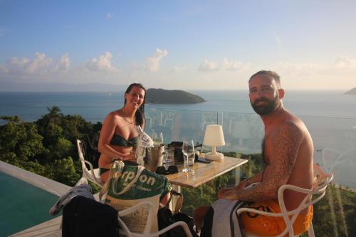 a man and a woman sitting at a table with a view at Bluerama - Adults Only in Haad Pleayleam