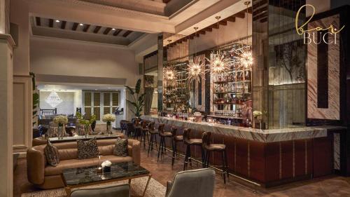 a bar in a restaurant with leather furniture at Jumeirah Dar Al Masyaf Dubai in Dubai