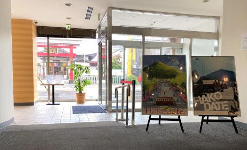 a store front with a sign in front of the door at Hotel Promote Hakodate in Hakodate