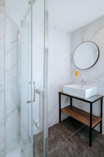 a bathroom with a sink and a mirror at Cosmo Napa Boutique Hotel in Ayia Napa