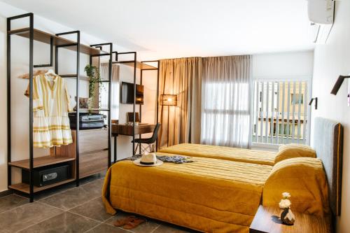 a hotel room with a bed and a desk at Cosmo Napa Boutique Hotel in Ayia Napa