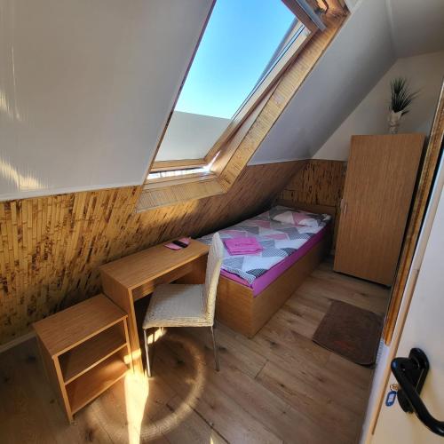 a room with a bed and a desk and a window at Pension Haus Baron 1 Neckarau in Mannheim